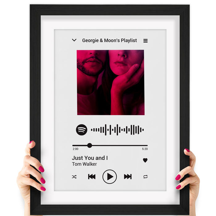 White Spotify poster-in-black frame